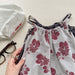 Lunea Kids Flora Volangbyxdress Flicka – Sommarjumpsuit i bomull – Blommönster – Volanger – 0–6 år – Luftiga barnkläder
